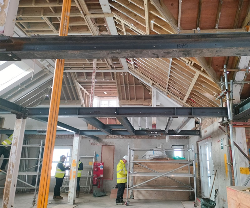 Basement Force employees inspecting structural modification